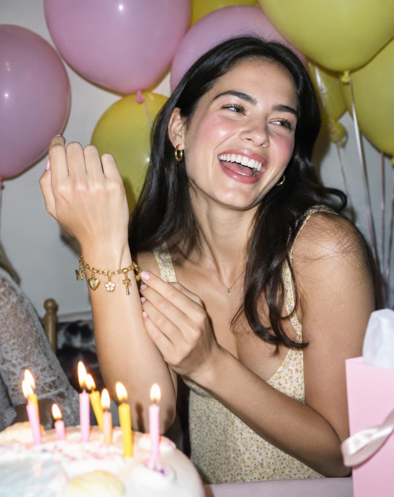 Smiling guest showing her charm bracelet at a party
